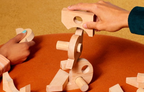 Players stacking Misfits wooden blocks